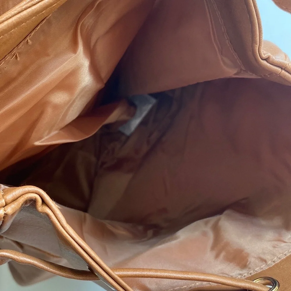 Brown backpack with zipper‎ accented detailing on front, NWOT